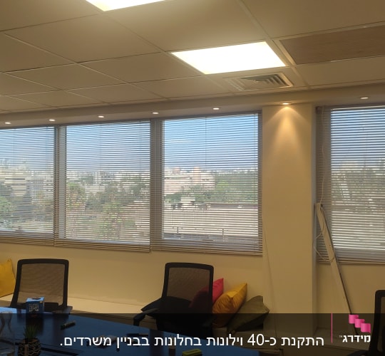 תריסים אופקיים על חלונות במשרד מואר